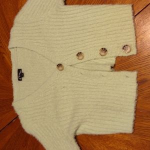 A fuzzy green cropped cardigan